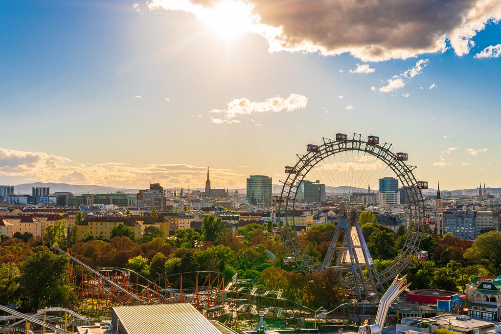 Stunning view of Vienna featuring the Giant Ferris Wheel and city skyline in sunlight.